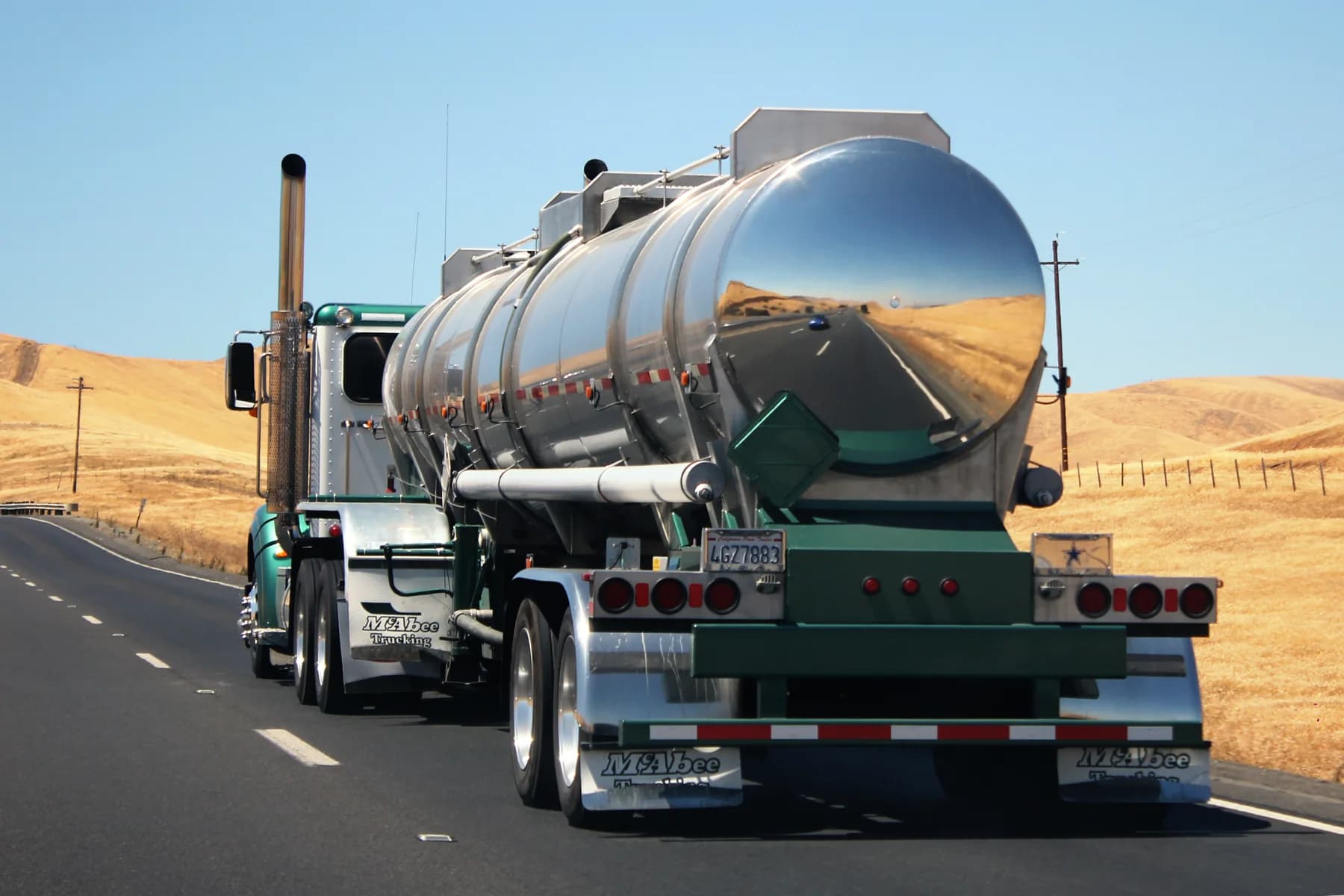 Tanker truck traveling on a divided highway.